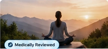 Person meditating in a mountain landscape
